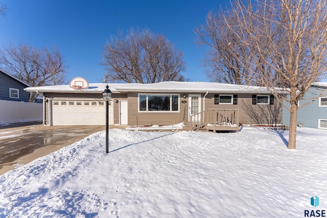 single story home featuring driveway, a garage, and fence