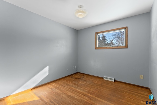 spare room featuring hardwood / wood-style flooring