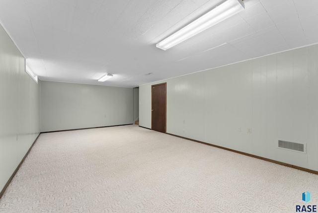 unfurnished room featuring light colored carpet