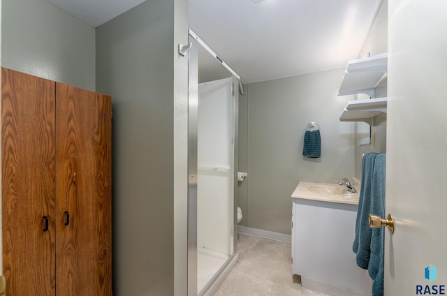 bathroom with vanity, a shower, tile patterned floors, and toilet