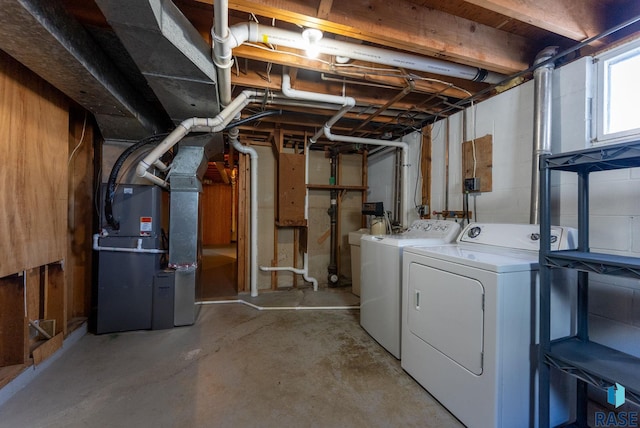 basement with separate washer and dryer and heating unit