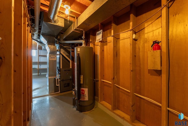 utility room with heating unit and gas water heater