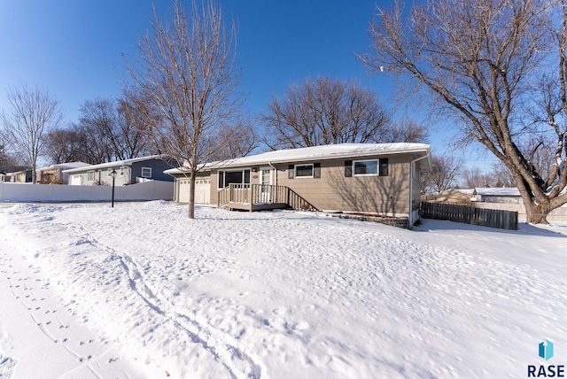 view of snow covered back of property