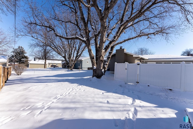 view of yard layered in snow