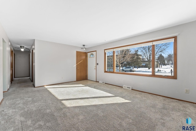 unfurnished living room featuring light carpet