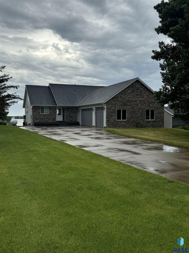 ranch-style home with a garage and a front lawn