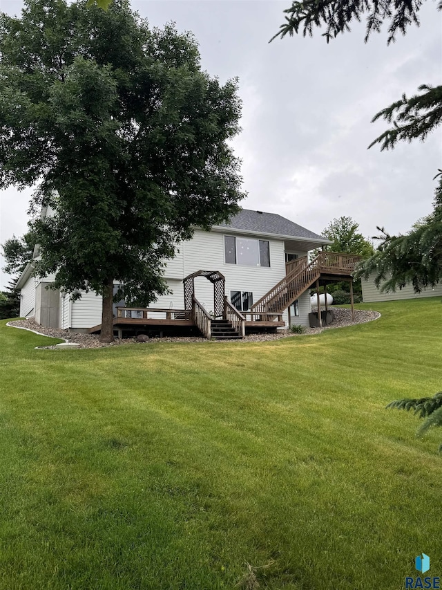 back of property with a deck, a shed, and a lawn