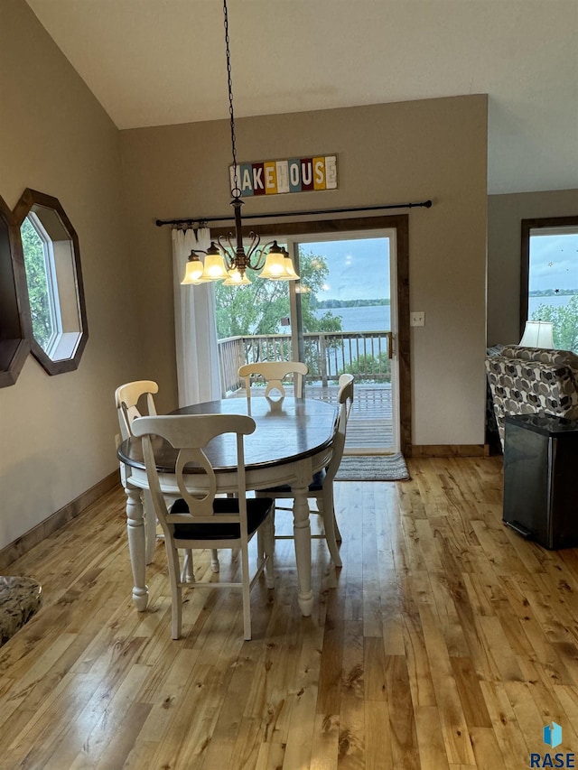 dining room featuring a wealth of natural light, a notable chandelier, and light hardwood / wood-style floors