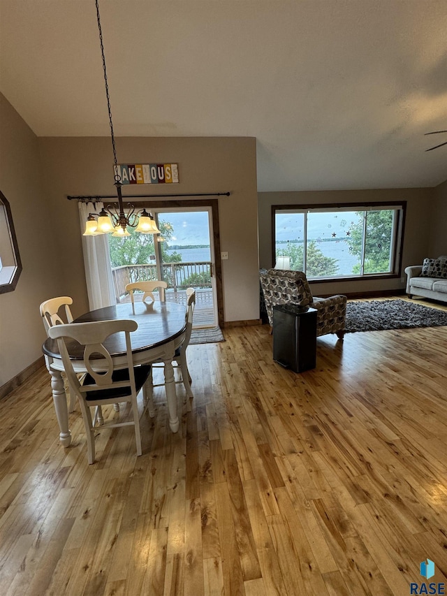 dining room with an inviting chandelier and light wood-type flooring