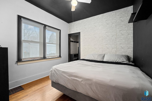 bedroom with wood-type flooring and ceiling fan