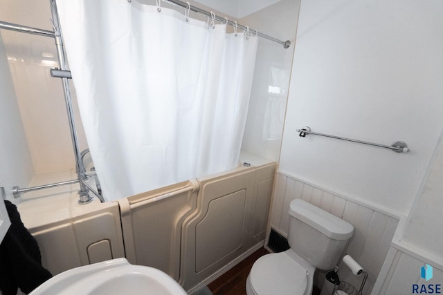 full bathroom with toilet, sink, and shower / bath combo with shower curtain