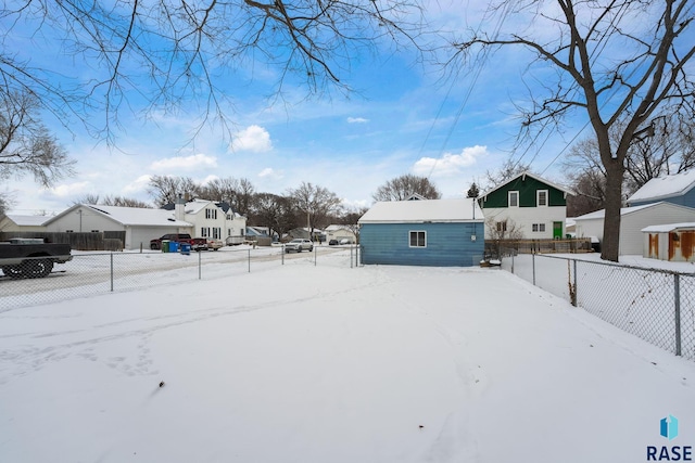 yard covered in snow featuring an outbuilding