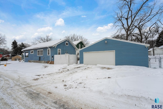 exterior space with a garage and an outdoor structure