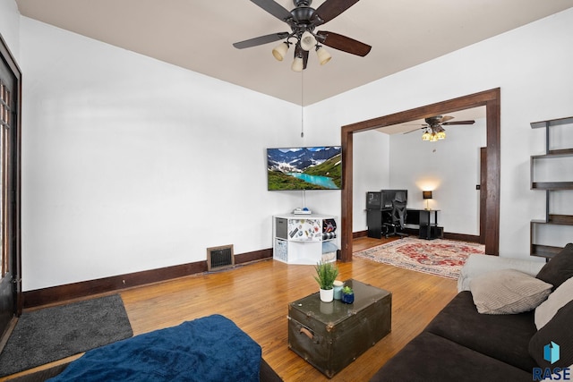 living room featuring hardwood / wood-style flooring and ceiling fan