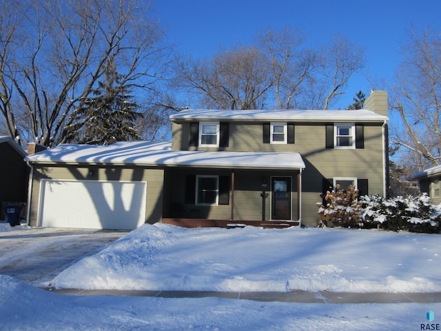 view of front facade with a chimney and an attached garage