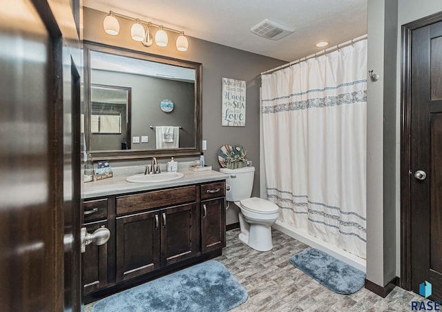 full bathroom featuring toilet, vanity, and shower / tub combo