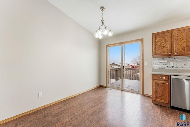 unfurnished dining area with lofted ceiling, hardwood / wood-style flooring, and a chandelier