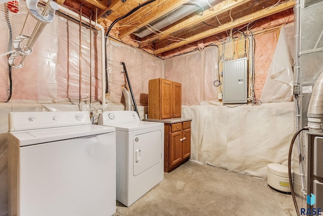 clothes washing area featuring cabinets, electric panel, and washer and clothes dryer