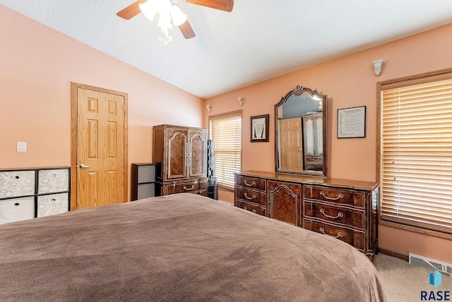 carpeted bedroom with ceiling fan and lofted ceiling