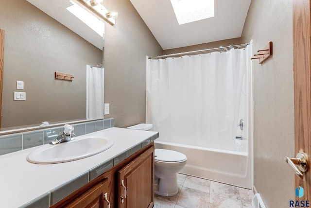 full bathroom with a skylight, shower / bath combination with curtain, tile patterned flooring, vanity, and toilet