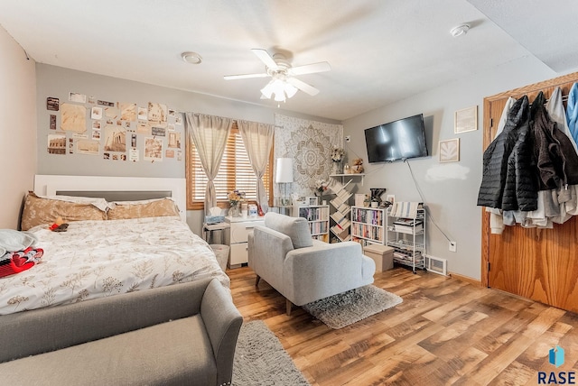 bedroom with ceiling fan and light hardwood / wood-style flooring