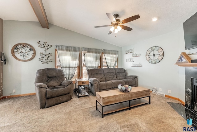 living room with lofted ceiling with beams, ceiling fan, light carpet, and a fireplace