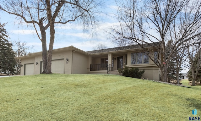 single story home with a front yard and a garage