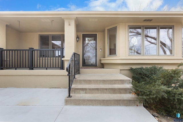 entrance to property with a porch