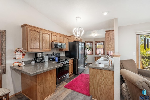 kitchen featuring lofted ceiling, appliances with stainless steel finishes, sink, light hardwood / wood-style flooring, and kitchen peninsula