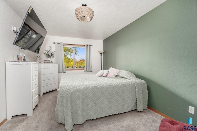 carpeted bedroom with a textured ceiling