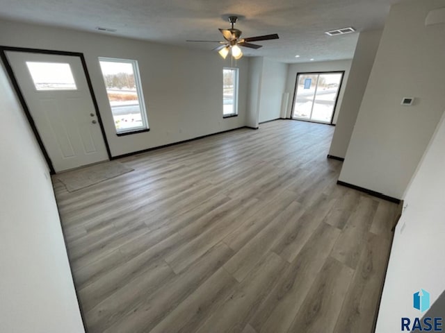 foyer entrance with light hardwood / wood-style flooring and ceiling fan