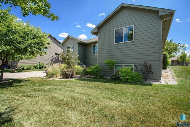 view of side of home featuring a lawn