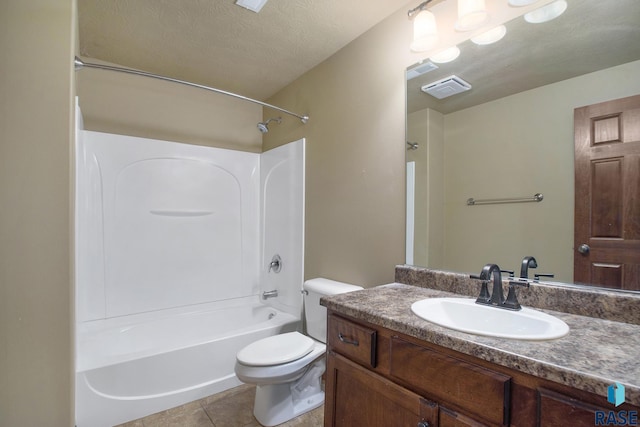 full bathroom featuring tile patterned floors, toilet, shower / bathing tub combination, a textured ceiling, and vanity