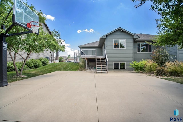 rear view of house with a yard and a deck