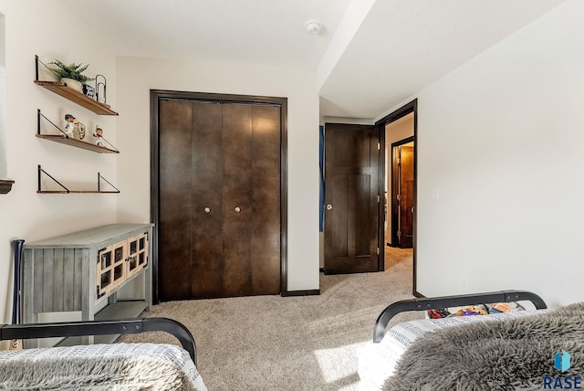 bedroom with a closet and light colored carpet