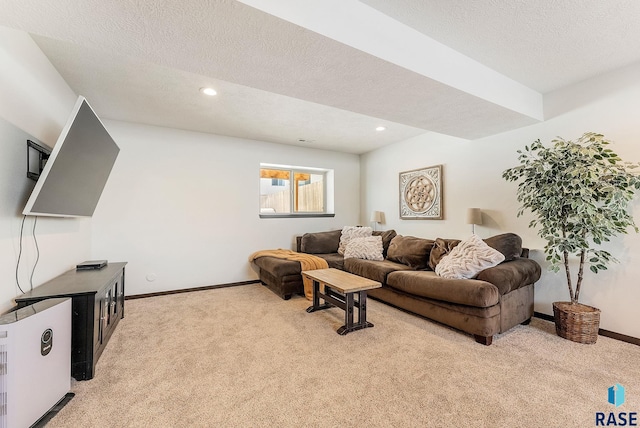 living room featuring light carpet and a textured ceiling