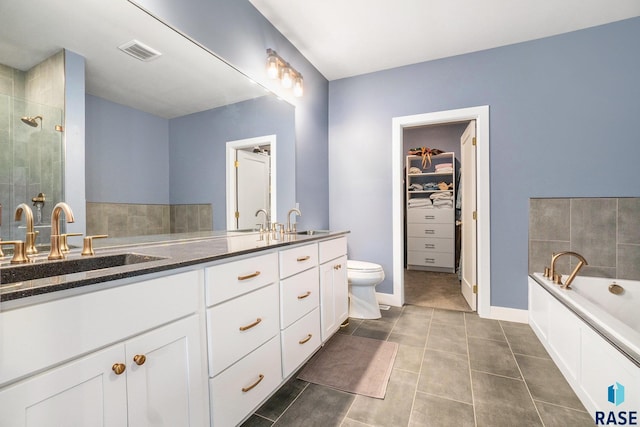 full bathroom with plus walk in shower, vanity, tile patterned flooring, and toilet