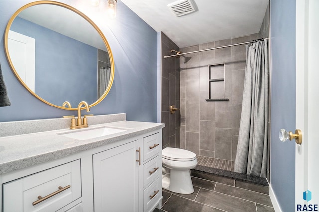 bathroom with a shower with shower curtain, vanity, toilet, and tile patterned floors