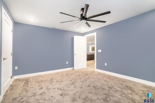 unfurnished bedroom with light colored carpet and ceiling fan