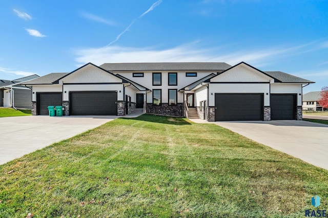 view of front of home with a garage and a front yard