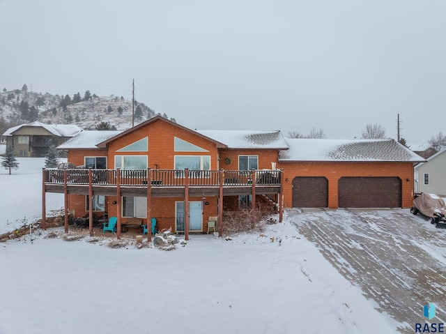 view of front of home featuring a garage and a deck