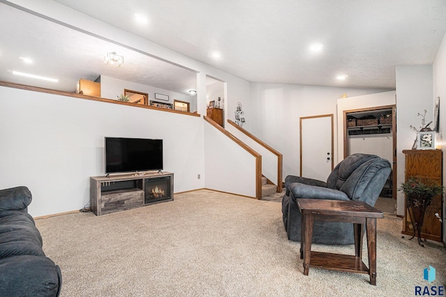 carpeted living room featuring vaulted ceiling