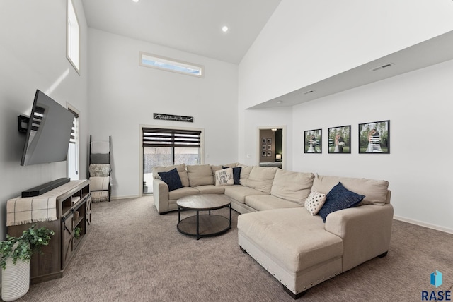 carpeted living room featuring a high ceiling