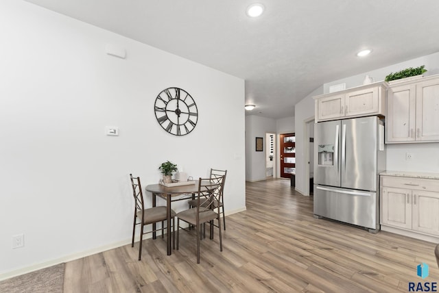 dining space with light hardwood / wood-style flooring