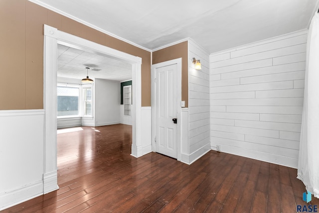 interior space featuring ornamental molding and dark hardwood / wood-style floors