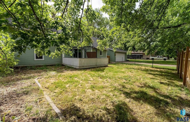 view of yard featuring a deck and a garage