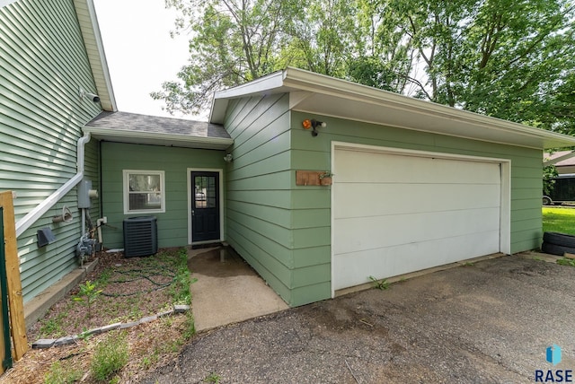 view of front facade with central AC and a garage