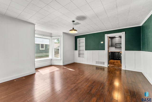 unfurnished room with ornamental molding and dark hardwood / wood-style floors