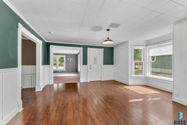 interior space with ornamental molding and hardwood / wood-style floors