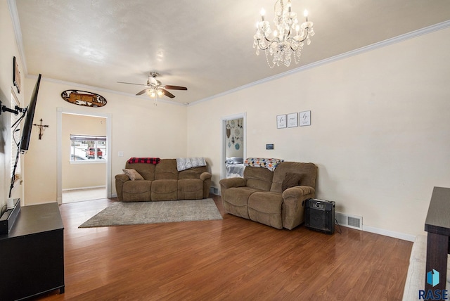 living room with ceiling fan with notable chandelier, hardwood / wood-style flooring, and ornamental molding